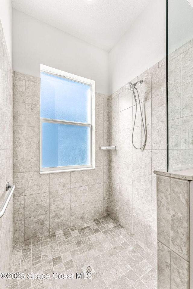 bathroom with a tile shower