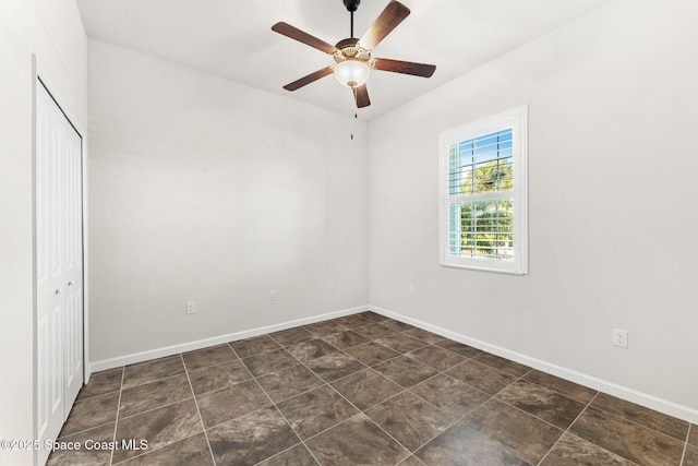 unfurnished bedroom with ceiling fan and a closet