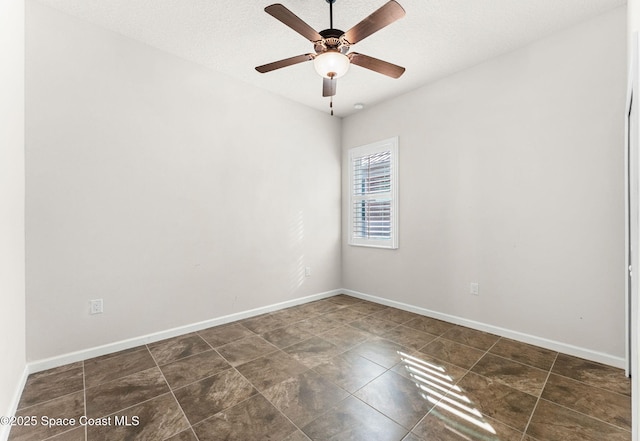 empty room with a textured ceiling and ceiling fan