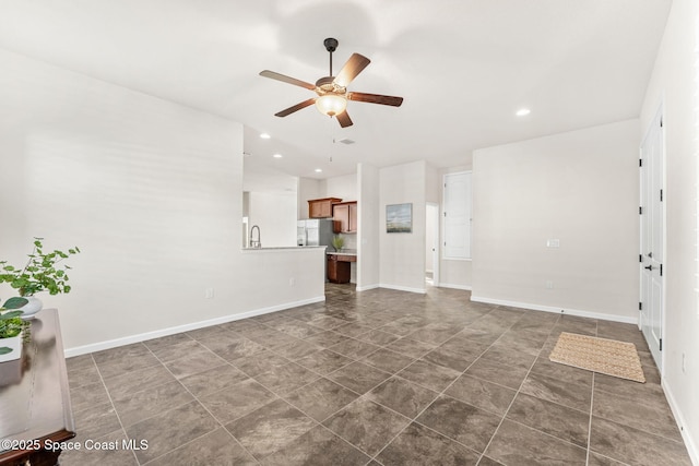 unfurnished living room with ceiling fan