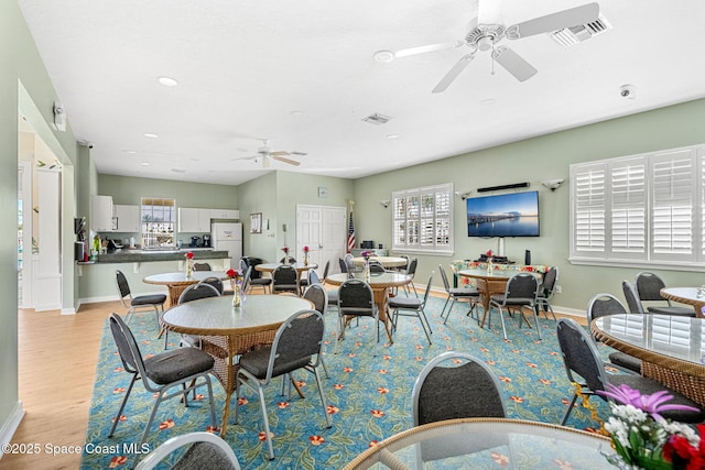 dining area featuring light hardwood / wood-style floors and ceiling fan