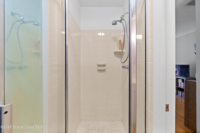 bathroom with a textured ceiling and walk in shower