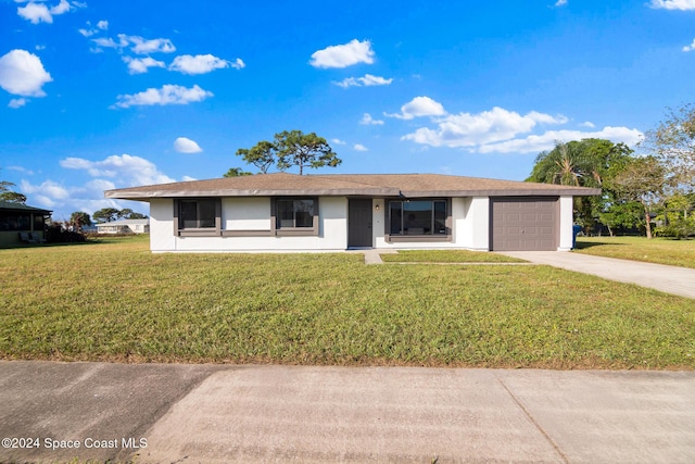 ranch-style house with a garage and a front yard