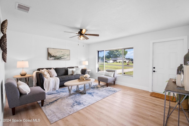 living room featuring ceiling fan and light wood-type flooring