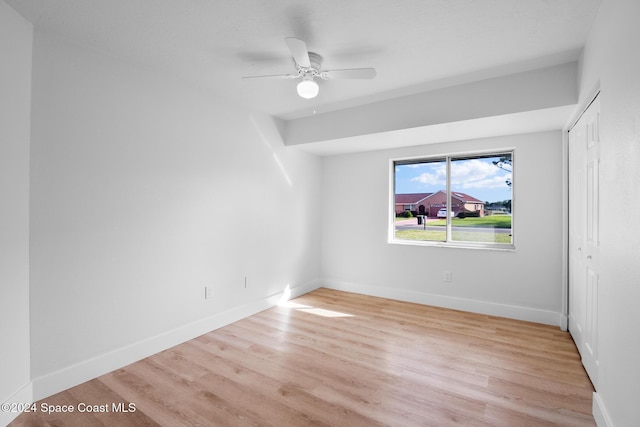 empty room featuring ceiling fan and light hardwood / wood-style floors