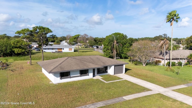 single story home featuring a garage and a front yard