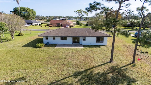 rear view of property with a lawn and a patio area