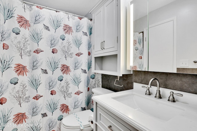 bathroom with vanity, toilet, and walk in shower