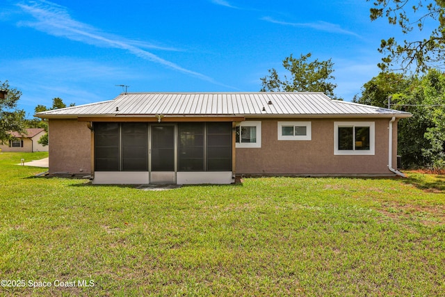 back of property featuring a yard