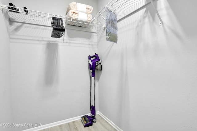 spacious closet featuring hardwood / wood-style floors