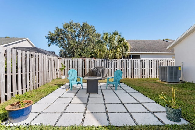 view of patio with a fire pit and central AC