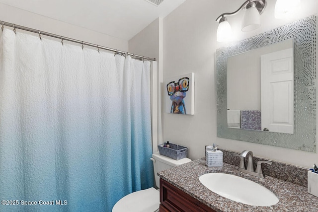 bathroom featuring toilet and vanity