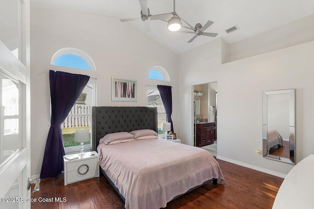 bedroom with ceiling fan, ensuite bath, dark hardwood / wood-style flooring, and multiple windows