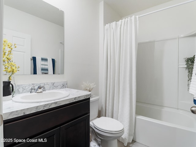 full bathroom with vanity, shower / tub combo, and toilet