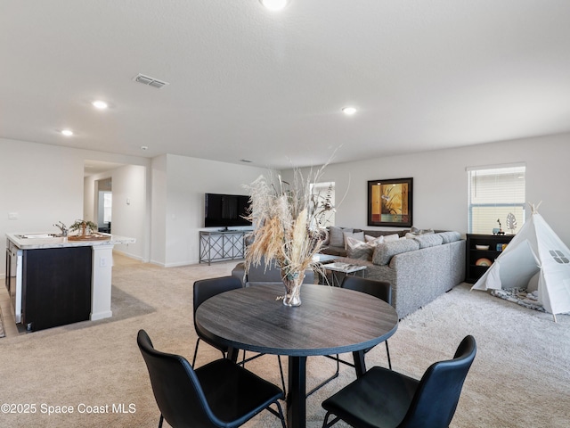 carpeted dining area featuring sink