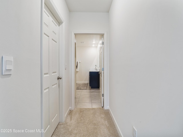 hallway featuring light carpet