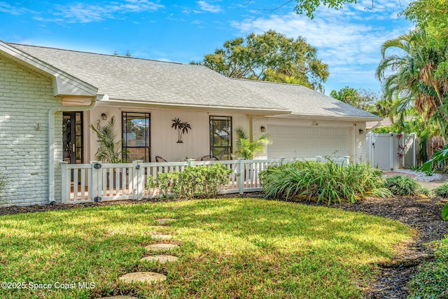 single story home featuring a garage and a front yard