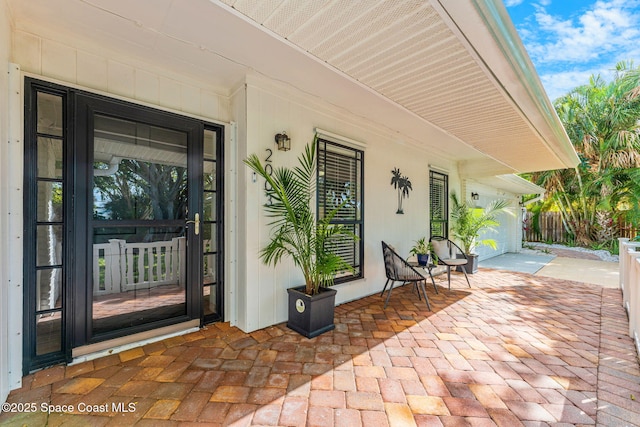 doorway to property with a garage and covered porch