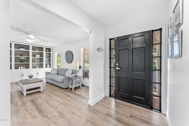 entrance foyer with ceiling fan, light hardwood / wood-style flooring, and a wealth of natural light