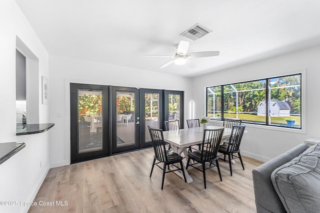 dining area featuring ceiling fan, a wealth of natural light, and light hardwood / wood-style floors