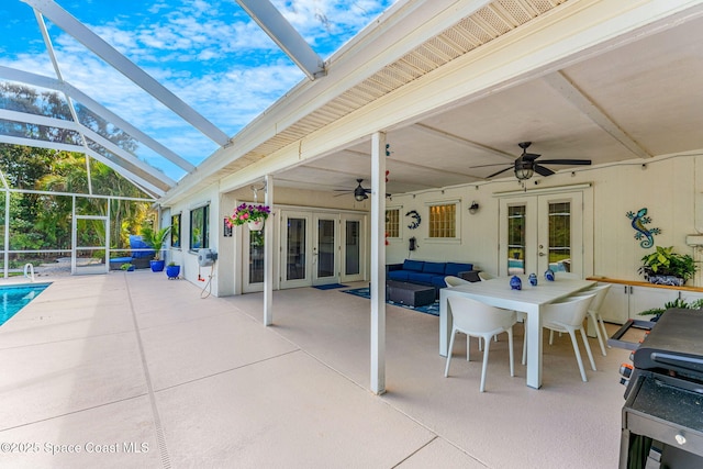 view of patio with a lanai, an outdoor hangout area, french doors, and ceiling fan