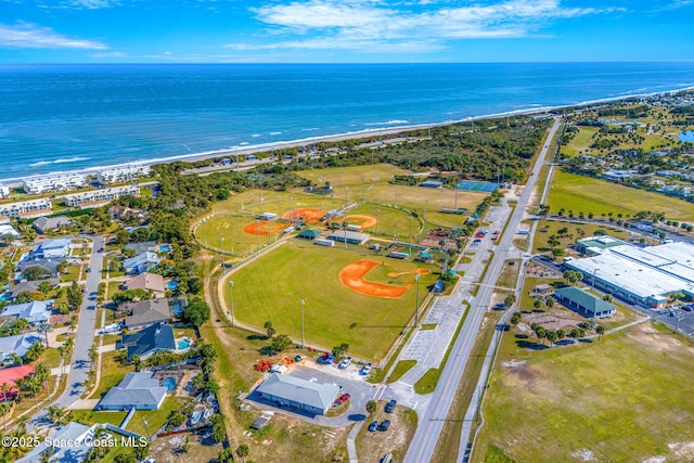 bird's eye view with a water view and a beach view