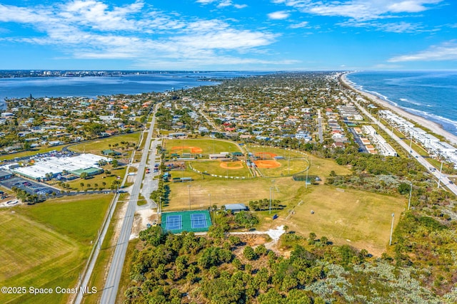 drone / aerial view featuring a water view and a view of the beach