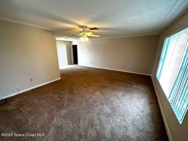 carpeted spare room with a textured ceiling and ceiling fan