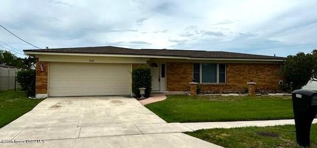 ranch-style home with a garage and a front yard