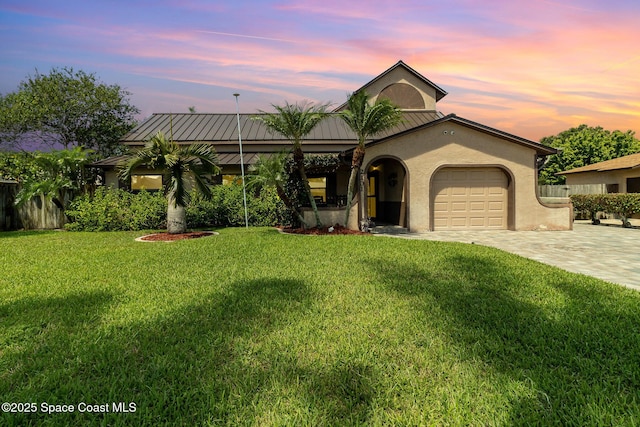 view of front of house featuring a yard and a garage