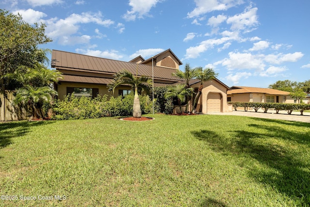 view of front of home with a front yard and a garage