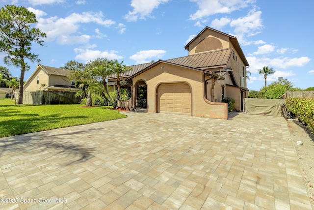 view of front of house with a garage and a front lawn