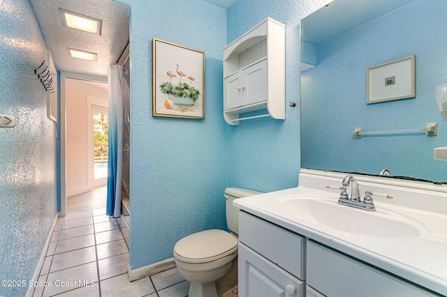 bathroom featuring a textured ceiling, toilet, vanity, and tile patterned flooring