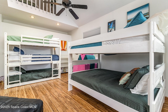 bedroom with ceiling fan, wood-type flooring, and vaulted ceiling