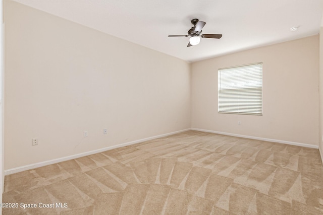 spare room featuring ceiling fan and light colored carpet