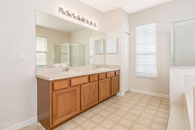 bathroom featuring separate shower and tub and vanity