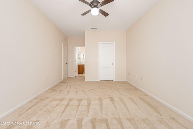 unfurnished bedroom with ceiling fan, ensuite bath, and light carpet