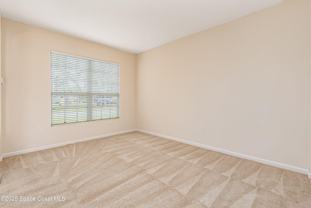 unfurnished room with light colored carpet