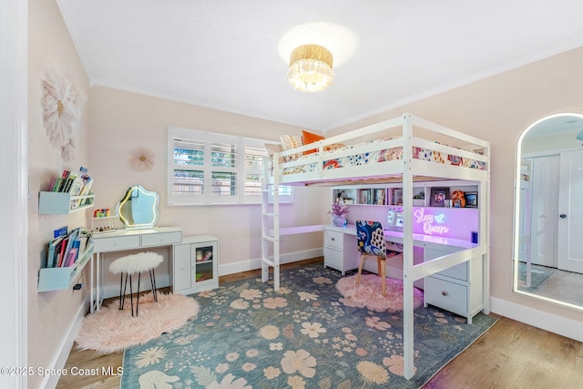 bedroom featuring crown molding and hardwood / wood-style floors