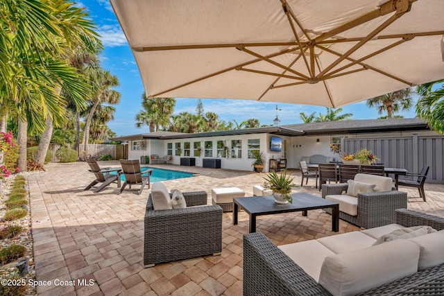 view of patio / terrace with a fenced in pool and outdoor lounge area