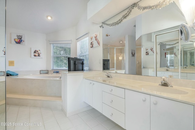 bathroom with tile patterned flooring, vanity, lofted ceiling, and independent shower and bath