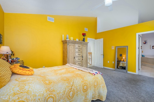 bedroom with ensuite bath, carpet floors, high vaulted ceiling, and ceiling fan