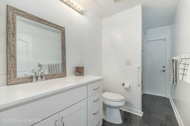 bathroom featuring vanity, tile patterned floors, and toilet