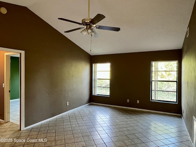 unfurnished room with high vaulted ceiling, light tile patterned floors, a textured ceiling, and ceiling fan