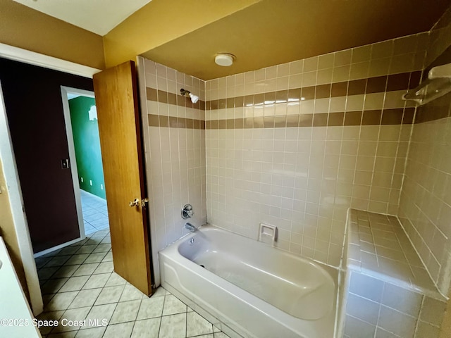 bathroom featuring tile patterned flooring and tiled shower / bath combo