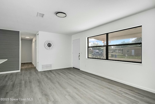 unfurnished room featuring hardwood / wood-style flooring