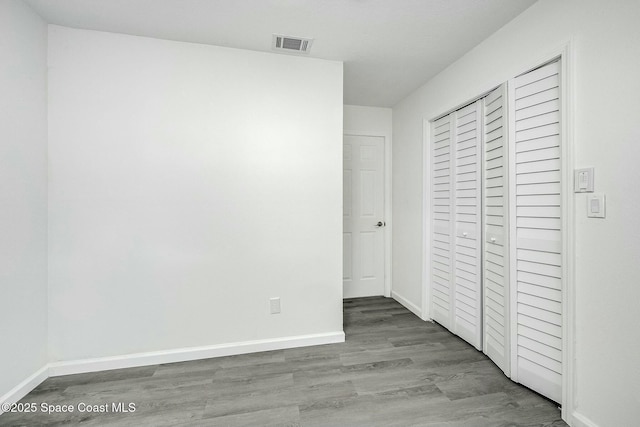 unfurnished bedroom with a closet and light hardwood / wood-style flooring