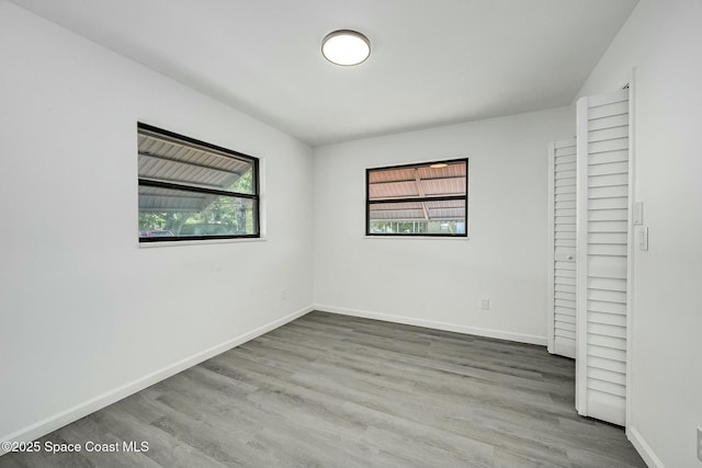 unfurnished bedroom featuring a closet and hardwood / wood-style flooring