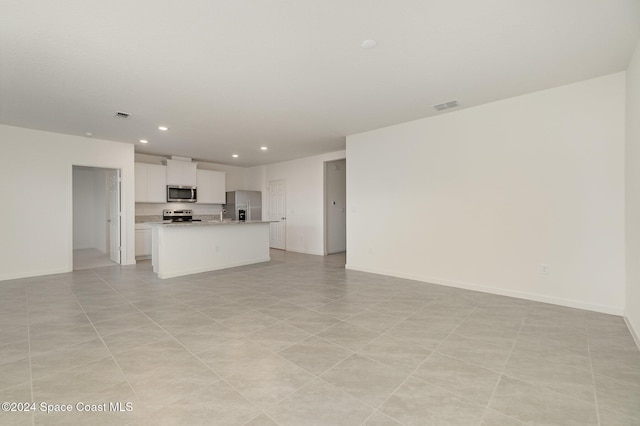 unfurnished living room featuring light tile patterned floors