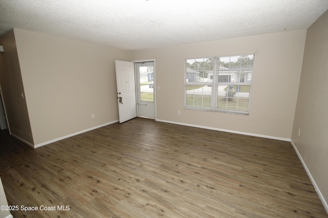 spare room featuring a textured ceiling and wood-type flooring